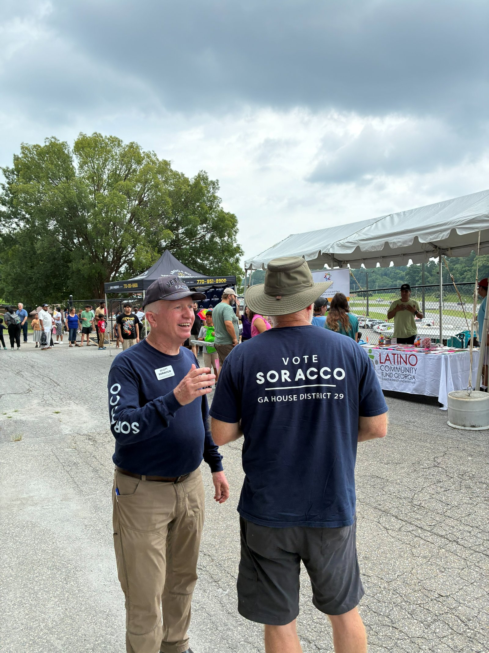 Scott Soracco talking with a volunteer at the Cumming Latin Festival